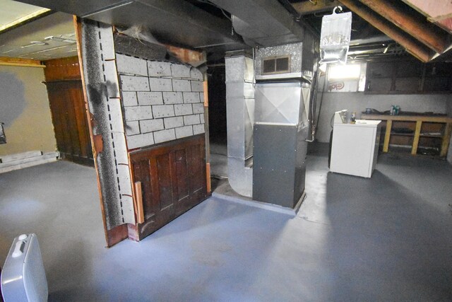 basement with heating unit and washer / dryer