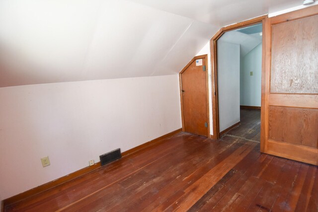 additional living space with dark hardwood / wood-style flooring and lofted ceiling