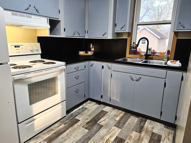 kitchen with sink, dark hardwood / wood-style flooring, backsplash, extractor fan, and white appliances