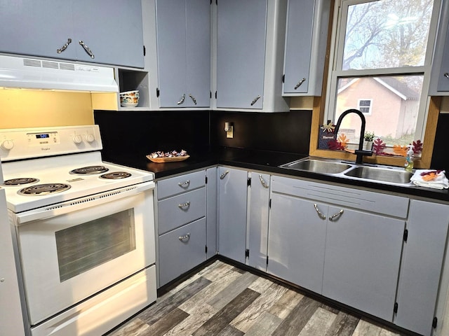 kitchen featuring white electric range oven, sink, gray cabinets, dark hardwood / wood-style floors, and range hood