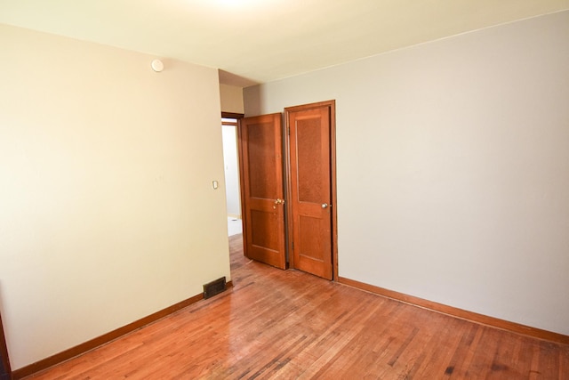 unfurnished room with light wood-type flooring