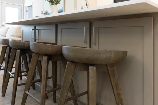 bar with light wood-type flooring