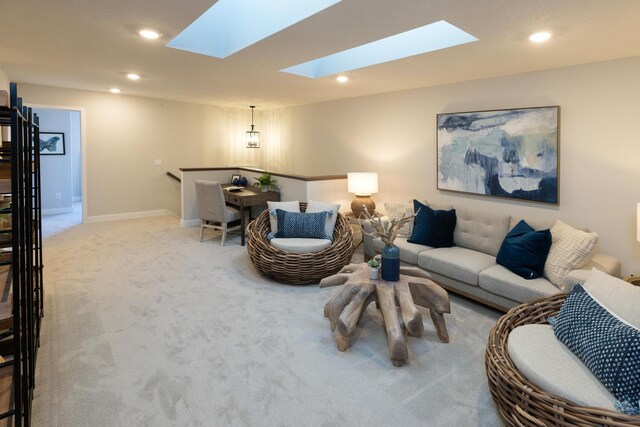 carpeted living room featuring a skylight