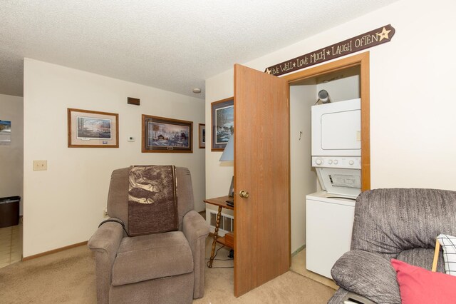 1600 Roundhouse Cir, Shakopee, MN 55379 - sitting room with stacked washer / drying machine, a textured ceiling, and light colored carpet