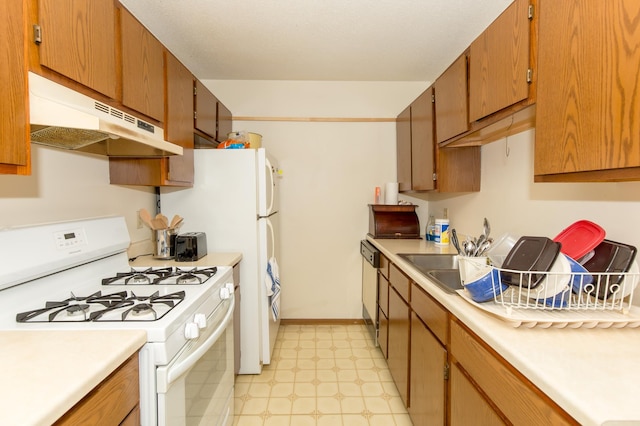 1600 Roundhouse Cir, Shakopee, MN 55379 - kitchen featuring light countertops, light floors, white gas range oven, and under cabinet range hood