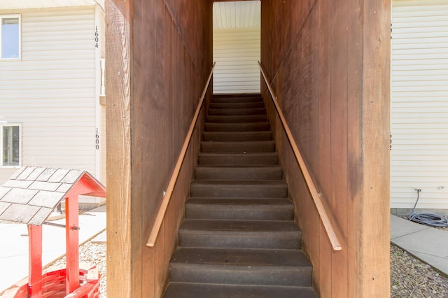1600 Roundhouse Cir, Shakopee, MN 55379 - staircase featuring wood walls