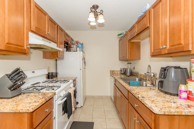 1600 Roundhouse Cir, Shakopee, MN 55379 - kitchen featuring brown cabinets, light tile patterned flooring, a sink, white appliances, and under cabinet range hood