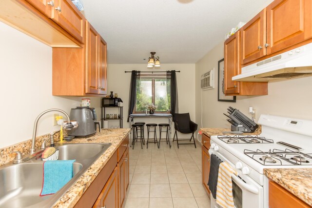 1600 Roundhouse Cir, Shakopee, MN 55379 - kitchen featuring a sink, white gas stove, a wall unit AC, light tile patterned floors, and under cabinet range hood