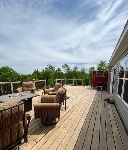 wooden terrace with an outdoor living space