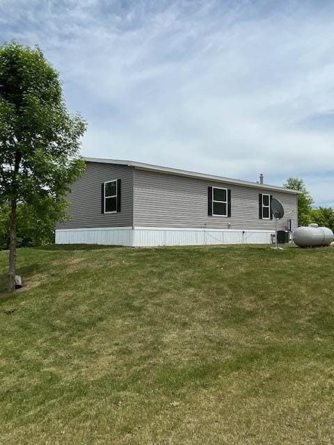 view of property exterior featuring a lawn