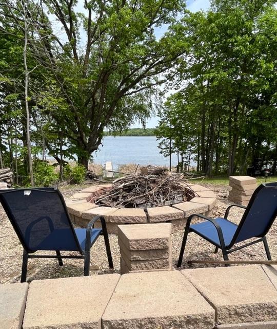 view of patio featuring a fire pit and a water view