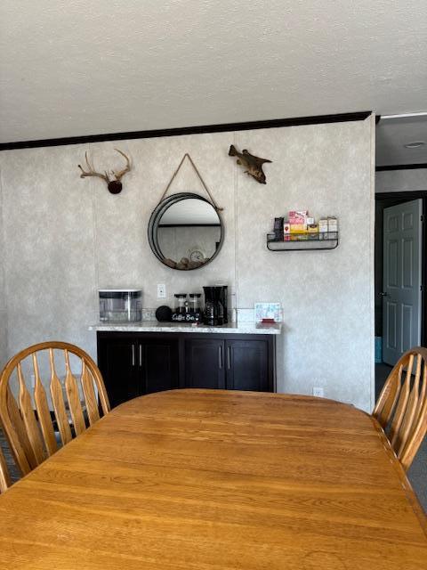 interior space featuring ornamental molding and a textured ceiling