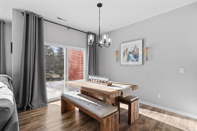 dining room with an inviting chandelier and hardwood / wood-style floors