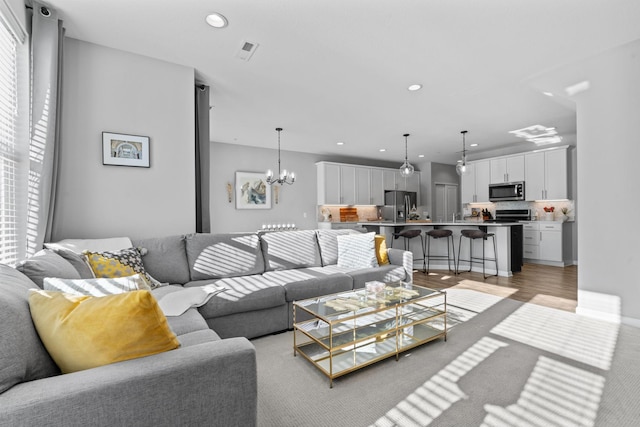 living room with an inviting chandelier