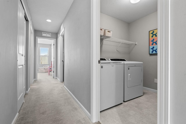 washroom featuring light carpet and washer and clothes dryer