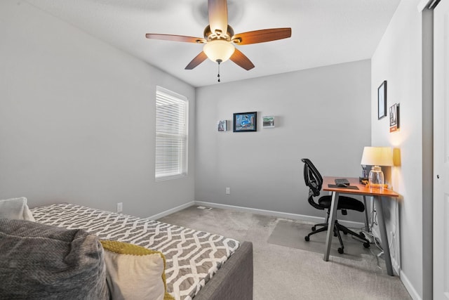 home office with ceiling fan and light colored carpet