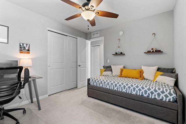 carpeted bedroom with a closet and ceiling fan