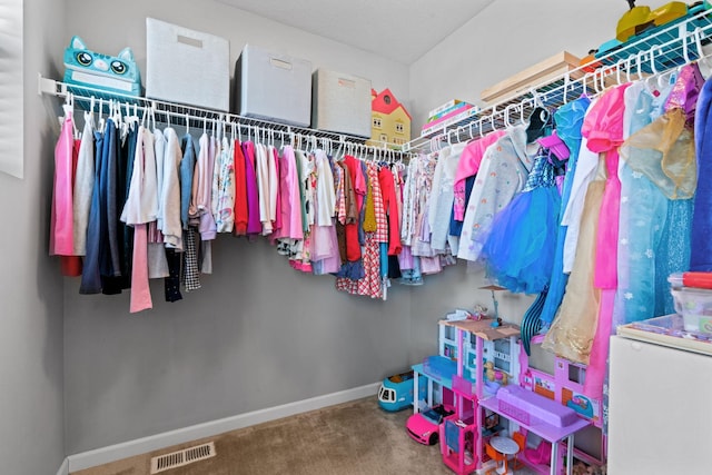 walk in closet with carpet floors