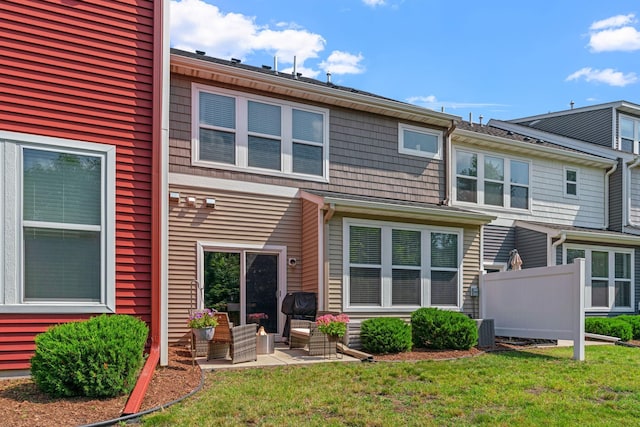 back of property featuring central air condition unit, a yard, and a patio