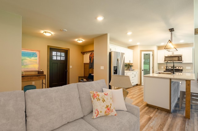 living room featuring recessed lighting and light wood finished floors