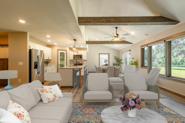 living area with baseboards, vaulted ceiling with beams, recessed lighting, ceiling fan, and light wood-type flooring
