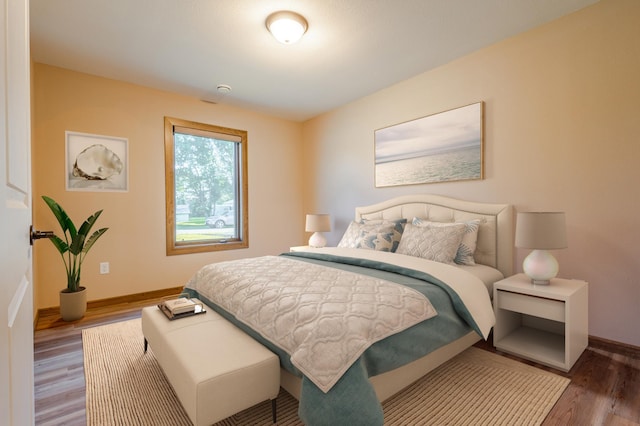 bedroom featuring baseboards and wood finished floors