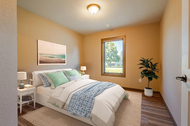 bedroom with wood finished floors and baseboards