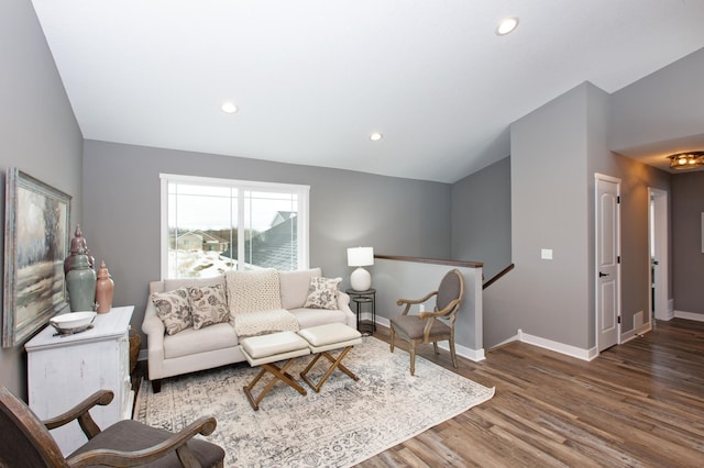 living room with hardwood / wood-style flooring and lofted ceiling