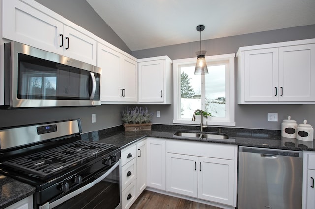 kitchen featuring stainless steel appliances, white cabinetry, and sink