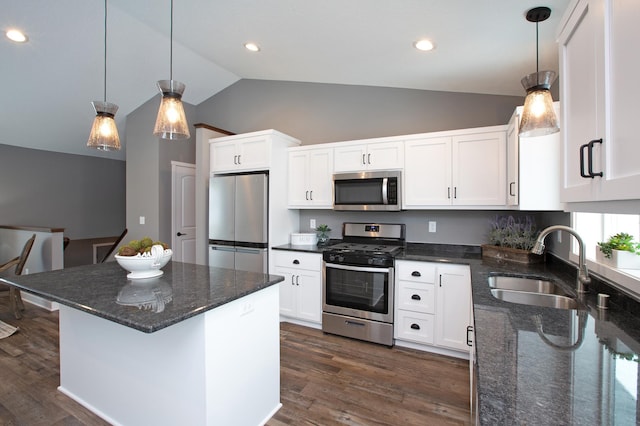 kitchen with white cabinetry, stainless steel appliances, sink, and hanging light fixtures