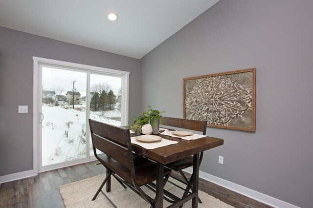 dining space with lofted ceiling and wood-type flooring