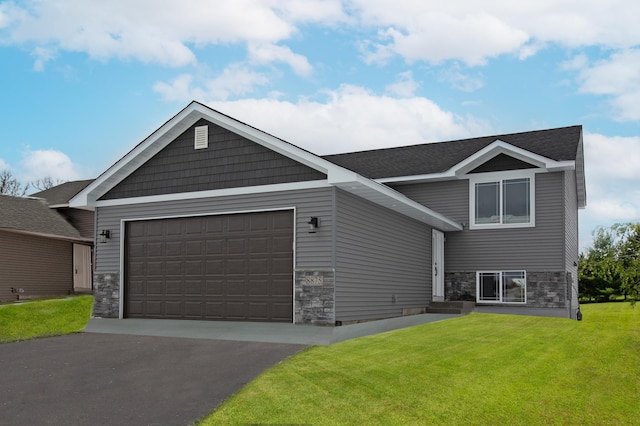 view of front of home featuring a garage and a front lawn