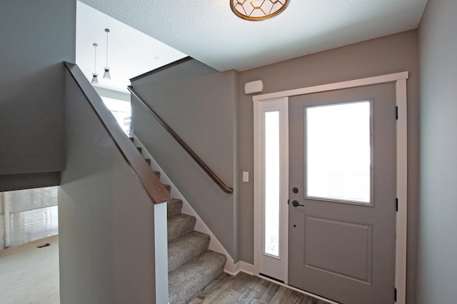 entrance foyer featuring a textured ceiling and hardwood / wood-style flooring