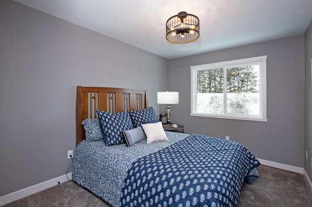 bedroom with carpet floors, a textured ceiling, and a chandelier