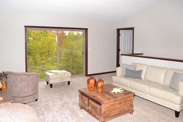 carpeted living room featuring a textured ceiling and lofted ceiling