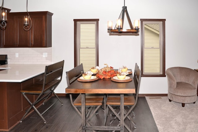 dining room featuring an inviting chandelier and dark hardwood / wood-style flooring