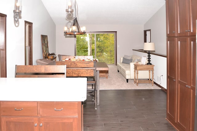 carpeted dining space with lofted ceiling and an inviting chandelier