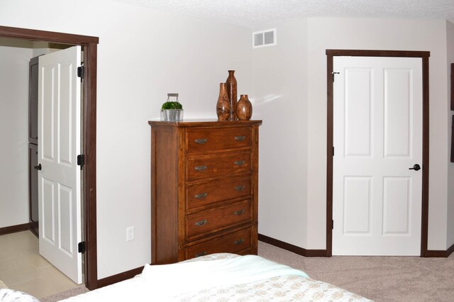 carpeted bedroom featuring a textured ceiling