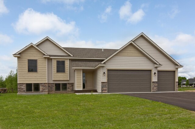 view of front of house with a garage and a front yard