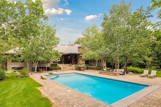 pool featuring outdoor dry bar, a patio, and a yard