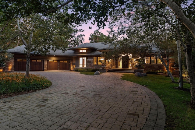 prairie-style house with a yard and a garage