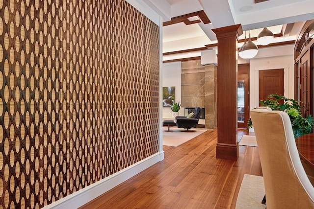 hall with decorative columns, coffered ceiling, hardwood / wood-style flooring, and beamed ceiling