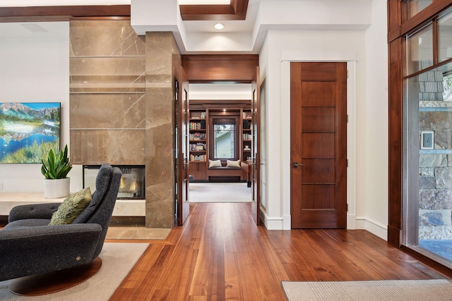 interior space featuring hardwood / wood-style floors, a fireplace, and a healthy amount of sunlight