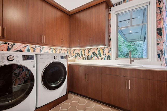 washroom with sink, washer and clothes dryer, light tile patterned flooring, and cabinets