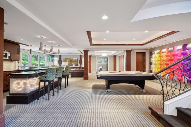 recreation room with light carpet, pool table, ornate columns, and a raised ceiling