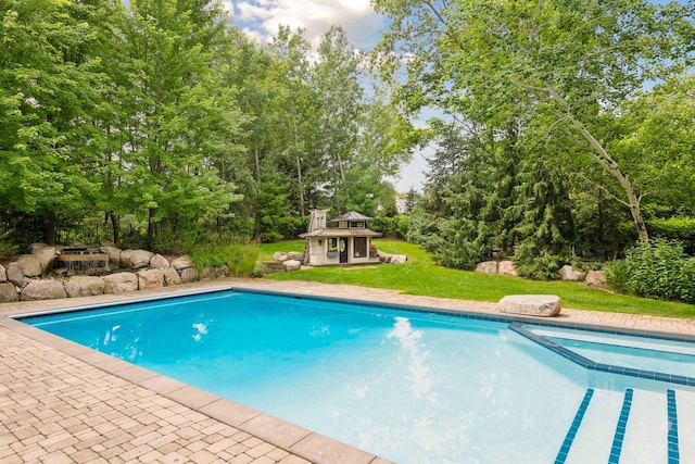 view of pool with a yard