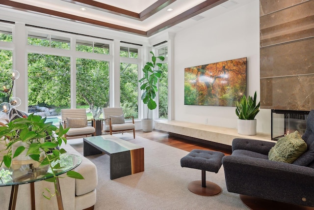 living room featuring a premium fireplace, wood finished floors, and recessed lighting