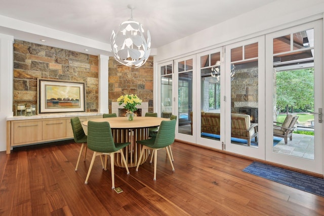 dining area featuring a chandelier and dark wood finished floors