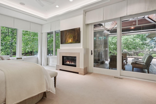 bedroom featuring carpet floors, access to outside, and a glass covered fireplace
