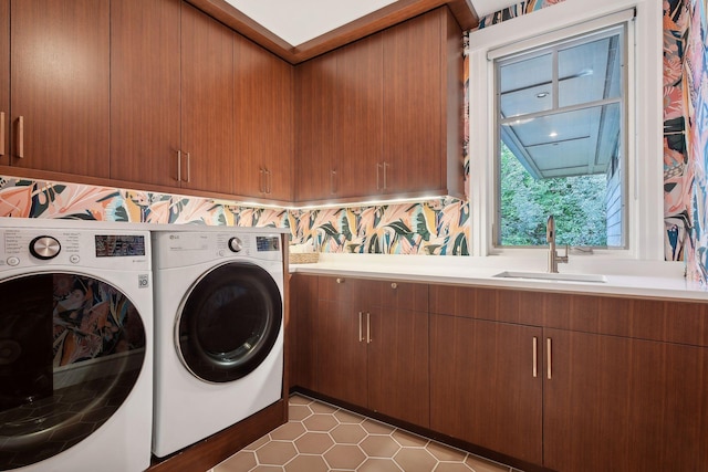 laundry area featuring cabinet space, washer and clothes dryer, and tile patterned floors